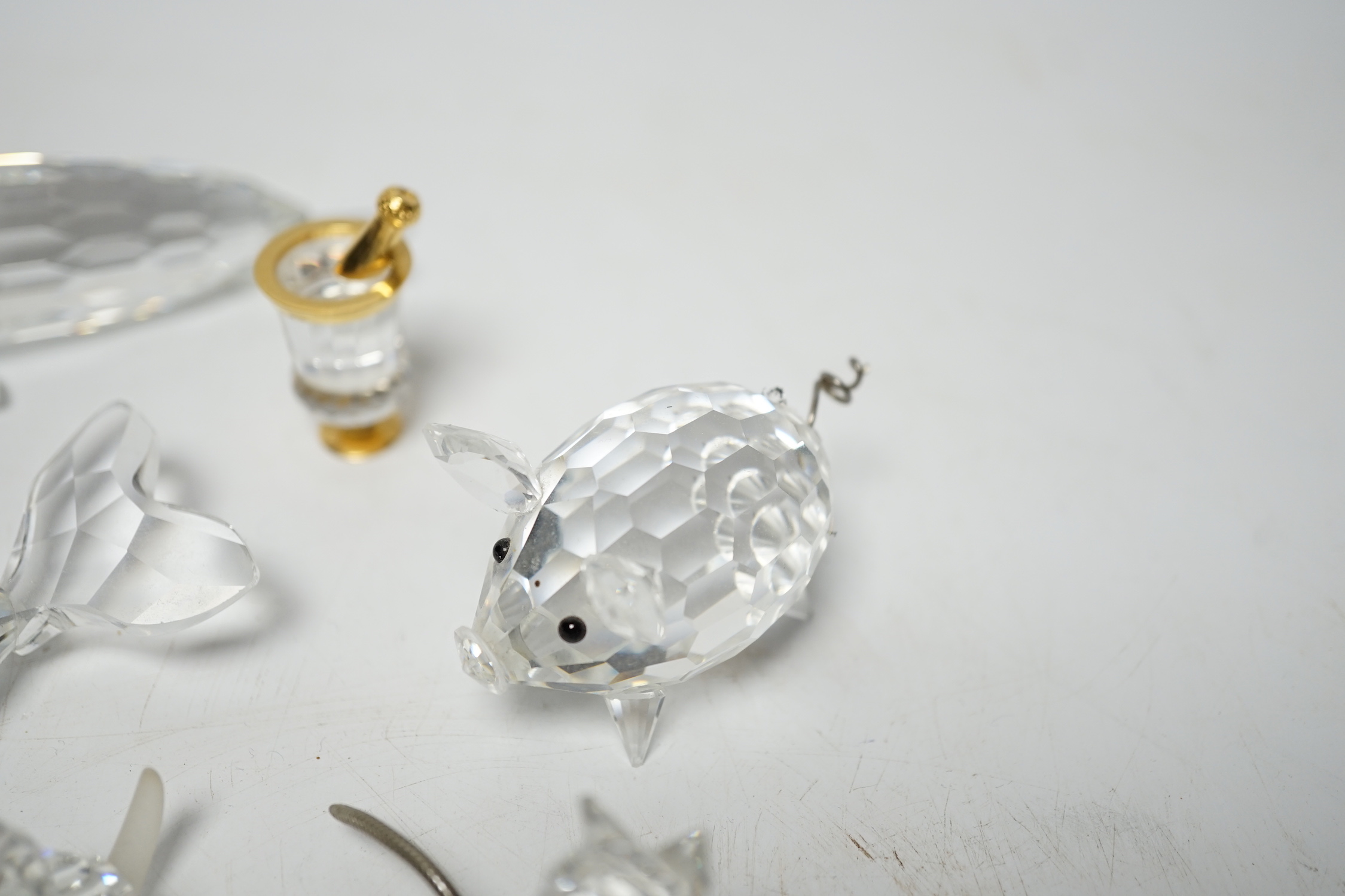 Eight Swarovski crystal animal ornaments and a miniature set of a Champagne cooler and two Champagne glass flutes, (11)